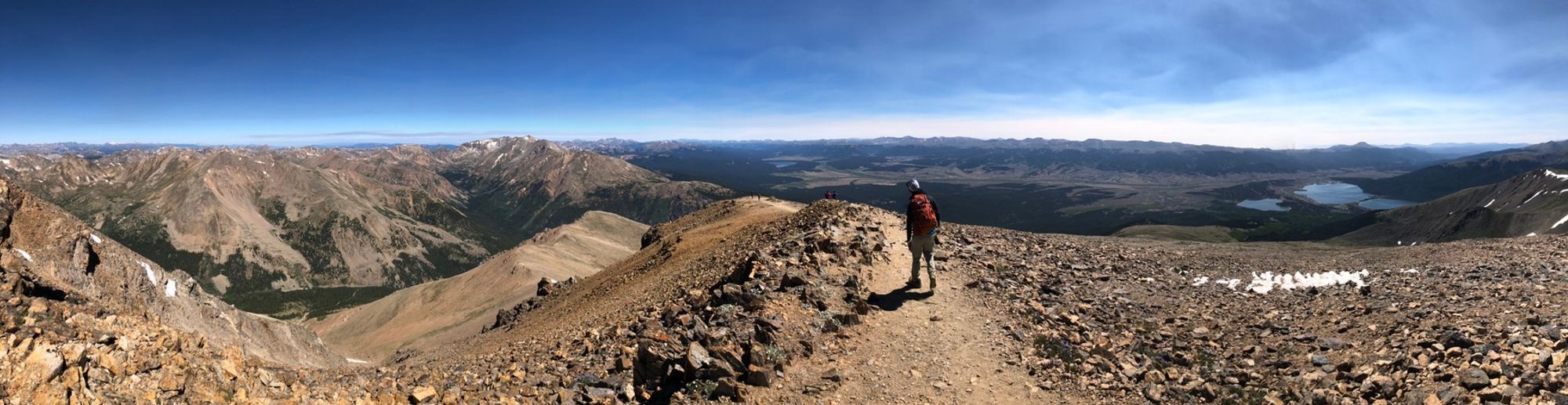 Ultra-wide panorama of Josh on the trail back down from the summit