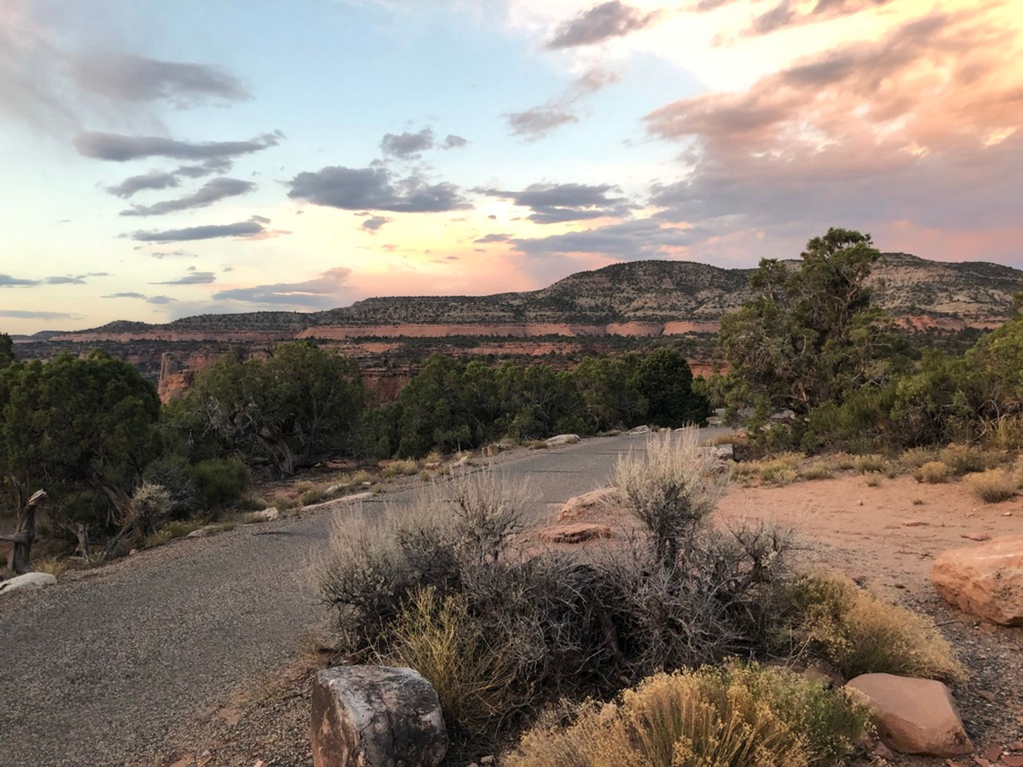 Sunrise from our campsite; gravel road in the foreground and mountains in the background.