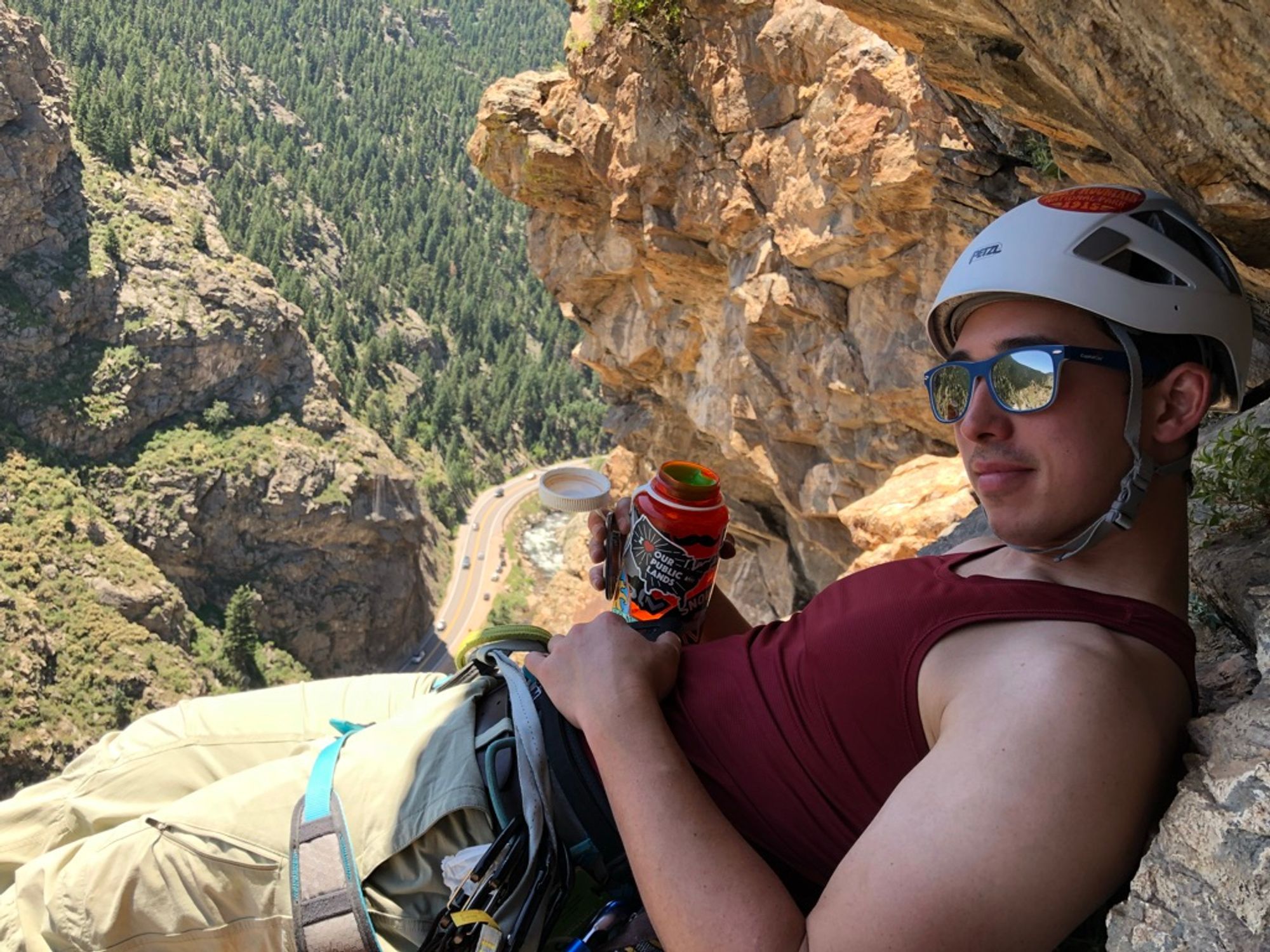 Josh taking a drink of water, in the shade, I believe at the top of the final pitch ~220ft above the ground.